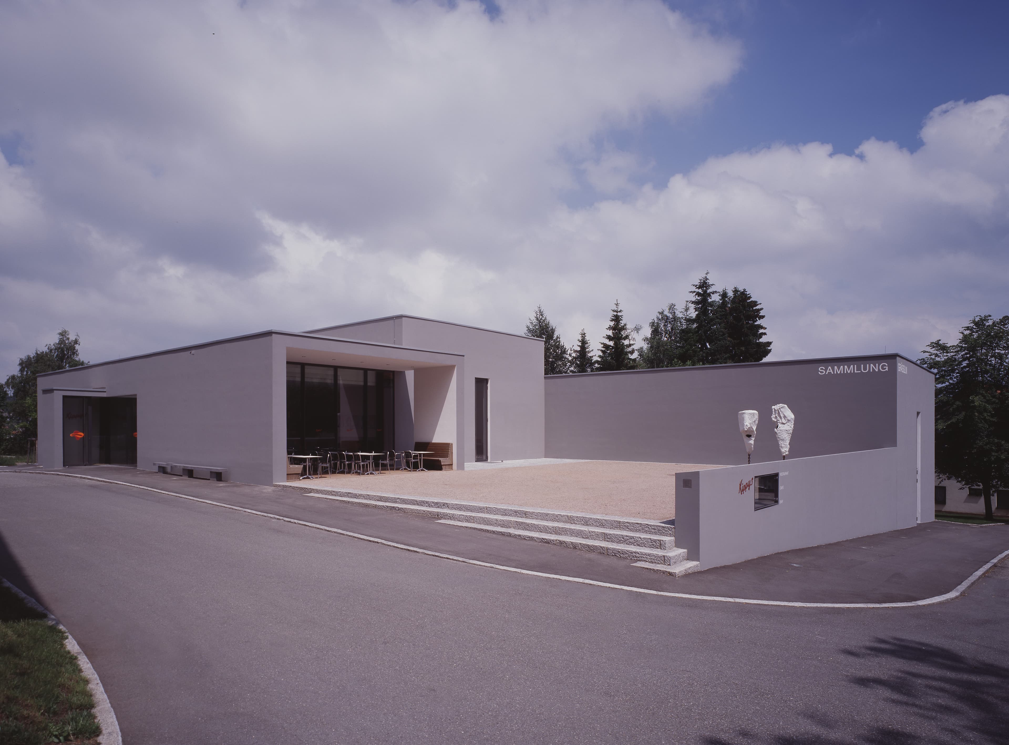White, artistic building against a summer sky